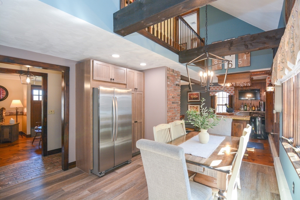 187 Blackstone Street Mendon, MA 01756 - Photo 11 of 42 a view of a dining room with furniture wooden floor and a chandelier
