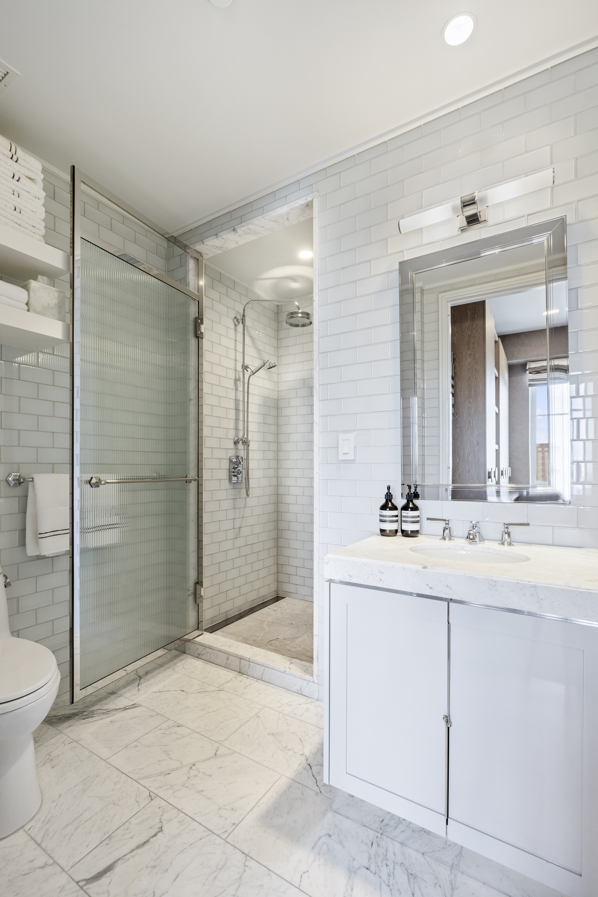 301 East 80th Street, Unit 25B Manhattan, NY 10075 - Photo 20 of 38 a bathroom with a shower sink and mirror
