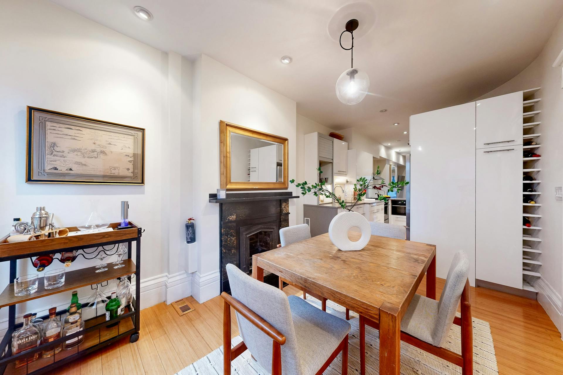 11 Fayette Street, Unit 1 Boston, MA 02116 - Photo 13 of 33 a kitchen with stainless steel appliances granite countertop a dining table chairs refrigerator and sink