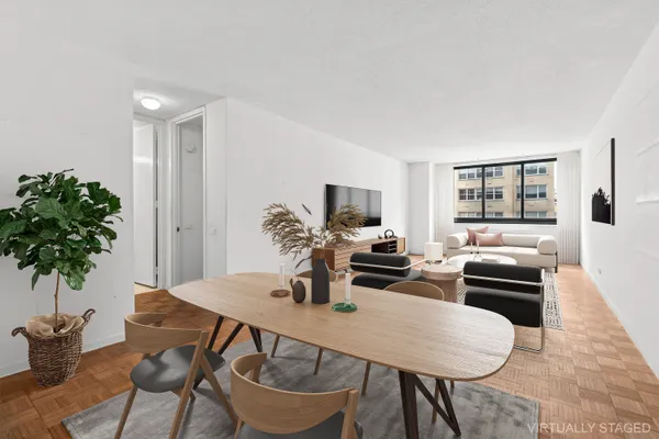 a dining room with furniture and wooden floor