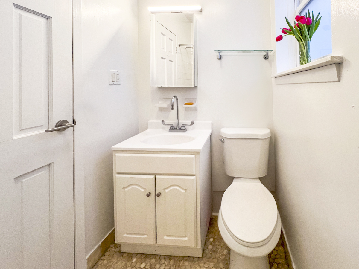 335 West 21st Street, Unit 4FE Manhattan, NY 10011 - Photo 7 of 11 a white toilet sitting next to a bathroom sink