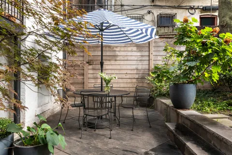 a wooden bench sitting in front of a building