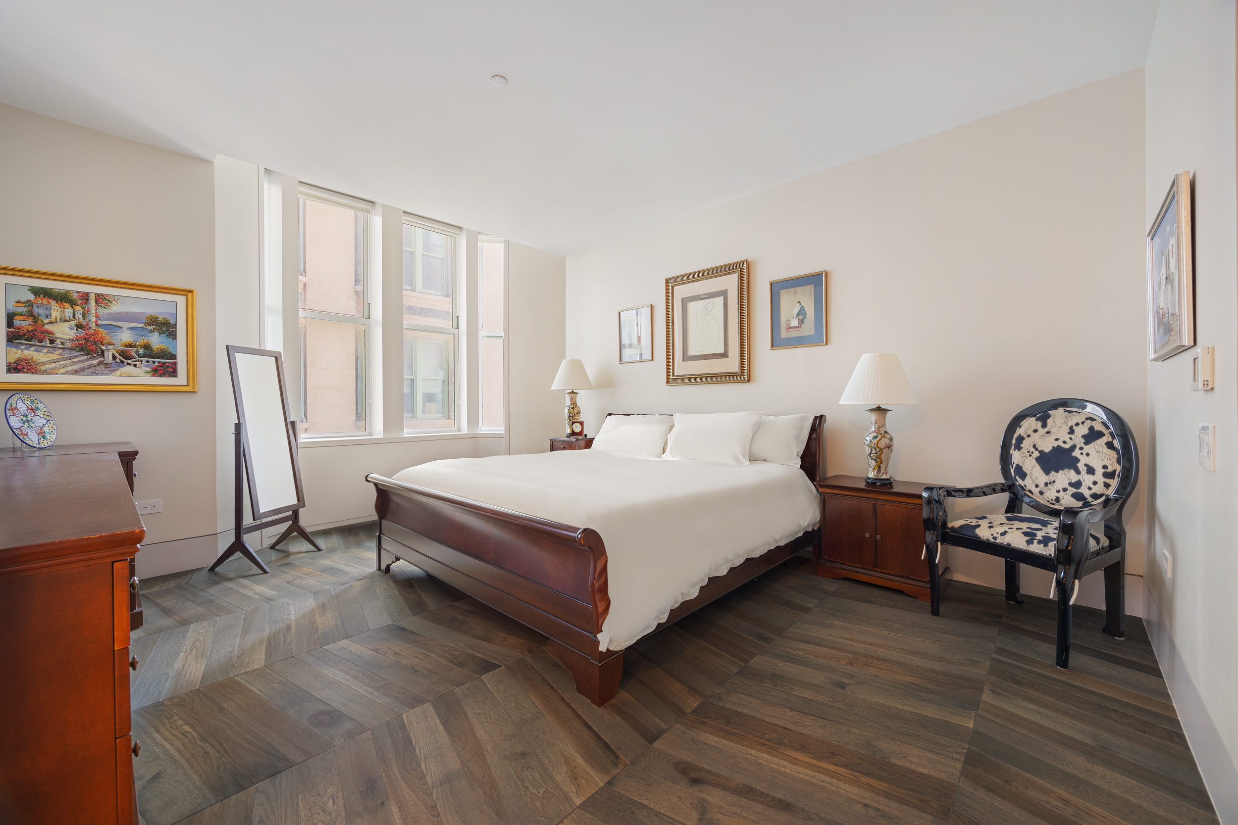 49 Chambers Street, Unit 14C Manhattan, NY 10007 - Photo 4 of 26 a spacious bedroom with a bed a table and a window