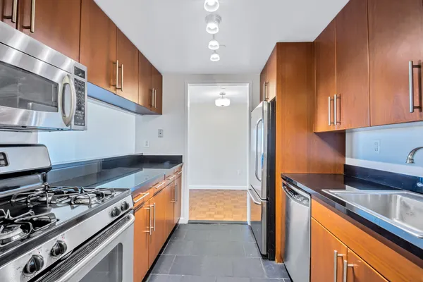 a kitchen with stainless steel appliances granite countertop a stove and a refrigerator