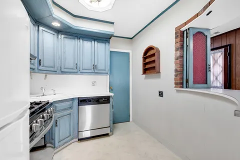 a kitchen with stainless steel appliances granite countertop a sink and a stove top oven