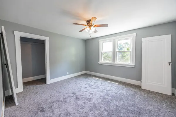 a view of an empty room with a ceiling fan