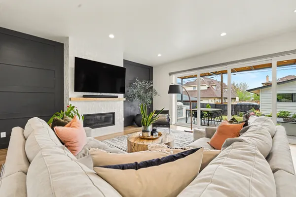 a living room with fireplace furniture and a flat screen tv