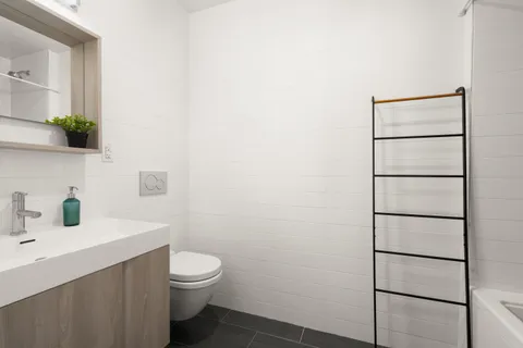 a bathroom with a toilet sink and shower