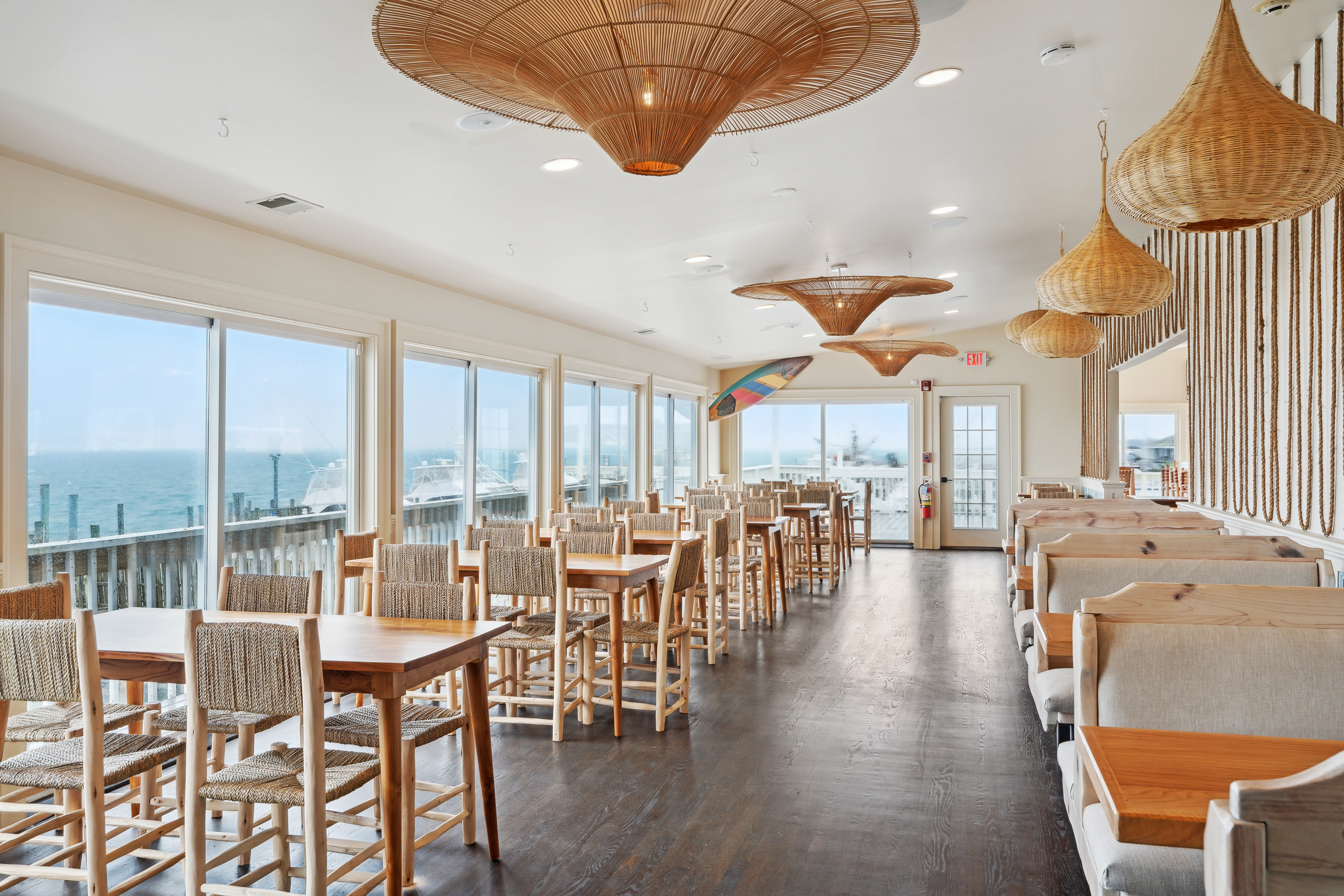 363 Beach Road Hampton Bays, NY 11959 - Photo 14 of 26 a dining room with furniture a chandelier and wooden floor