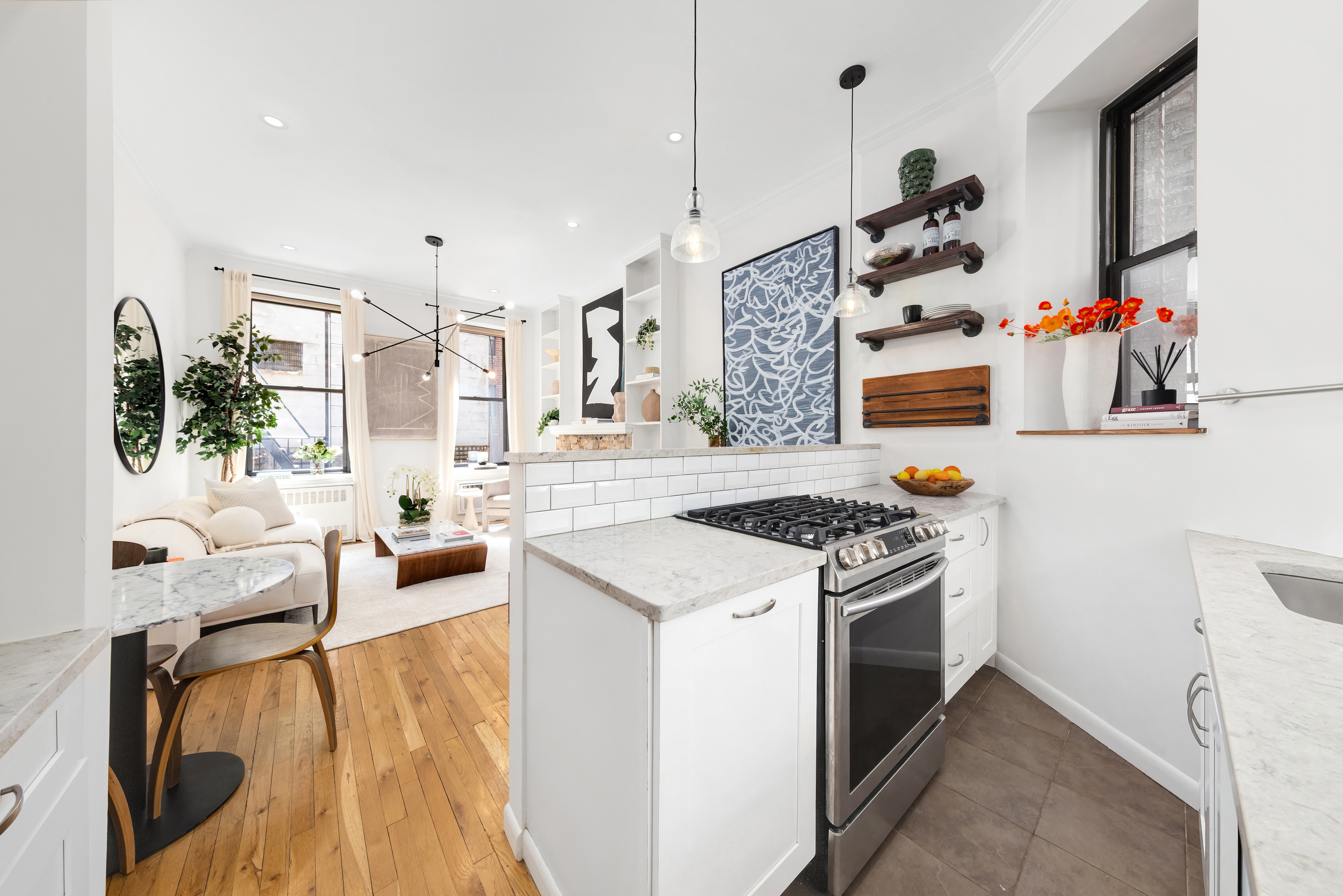 170 East 92nd Street, Unit 1D Manhattan, NY 10128 - Photo 6 of 12 a kitchen with a stove and a wooden floor