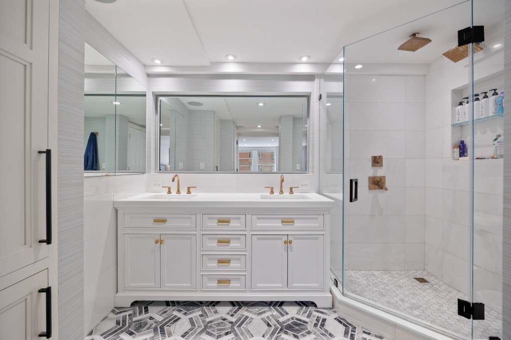 433 West 34th Street, Unit 4ABC Manhattan, NY 10001 - Photo 13 of 20 a bathroom with a shower sink and mirror