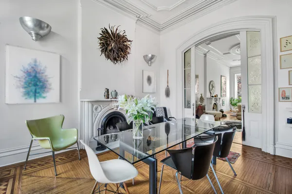 a view of a dining room with furniture wooden floor and a chandelier