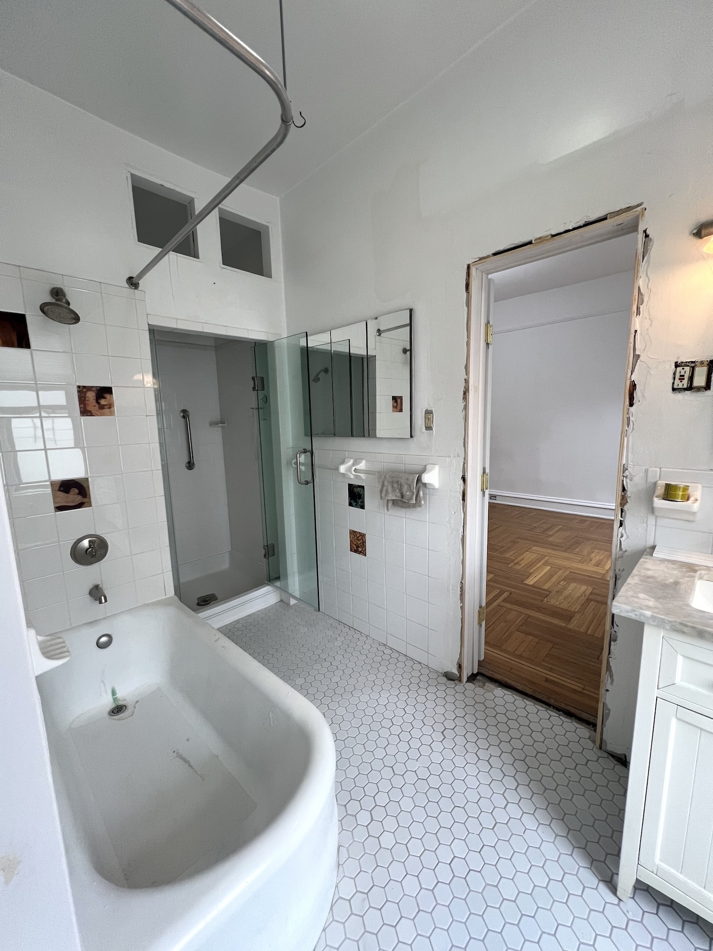 59 Livingston Street, Unit 3A Brooklyn, NY 11201 - Photo 7 of 19 a bathroom with a tub sink and mirror