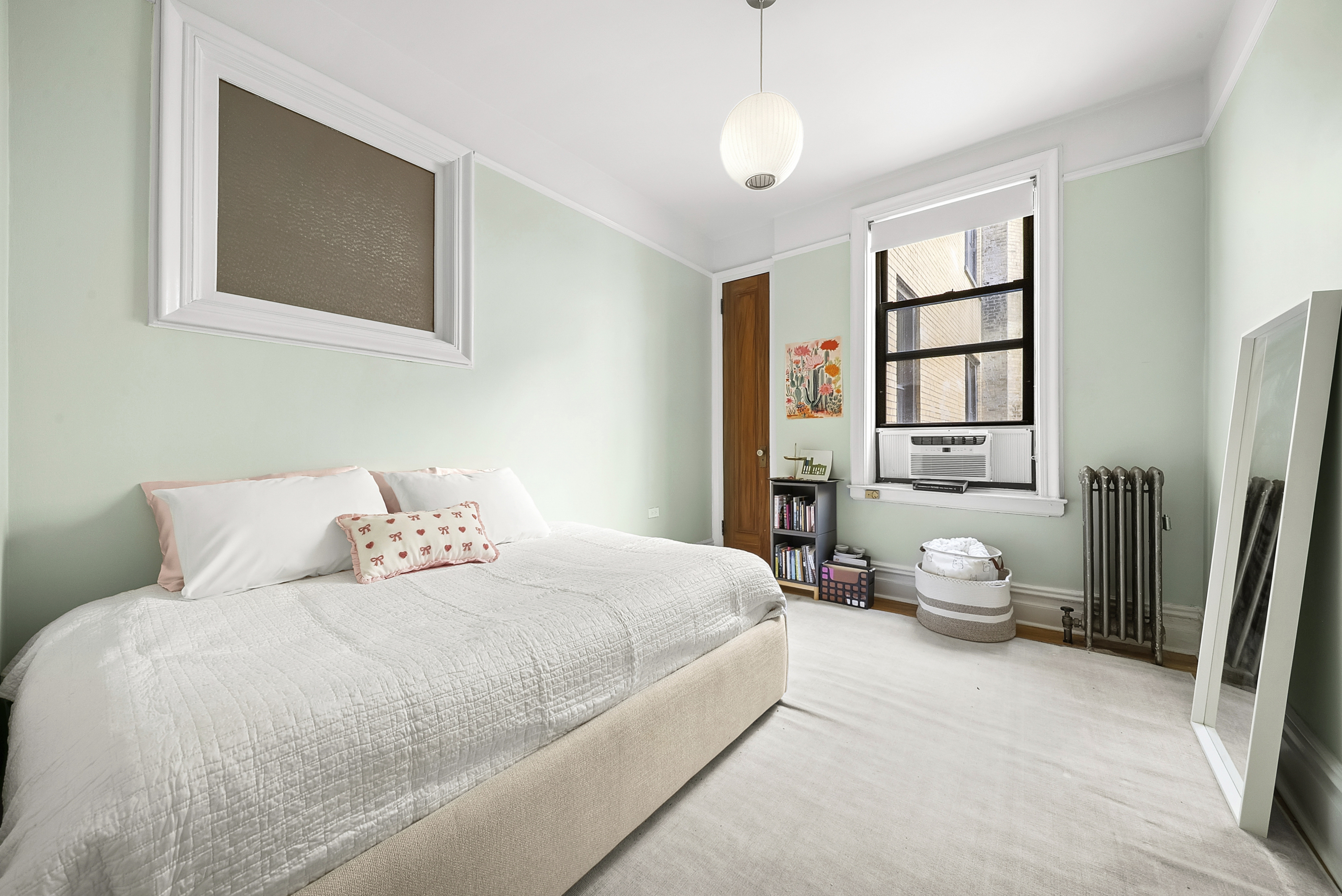 536 West 111th Street, Unit 66 Manhattan, NY 10025 - Photo 6 of 8 a bedroom with a bed couch and a window