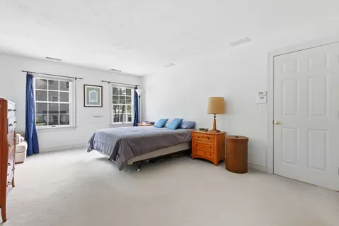 a spacious bedroom with a bed and window