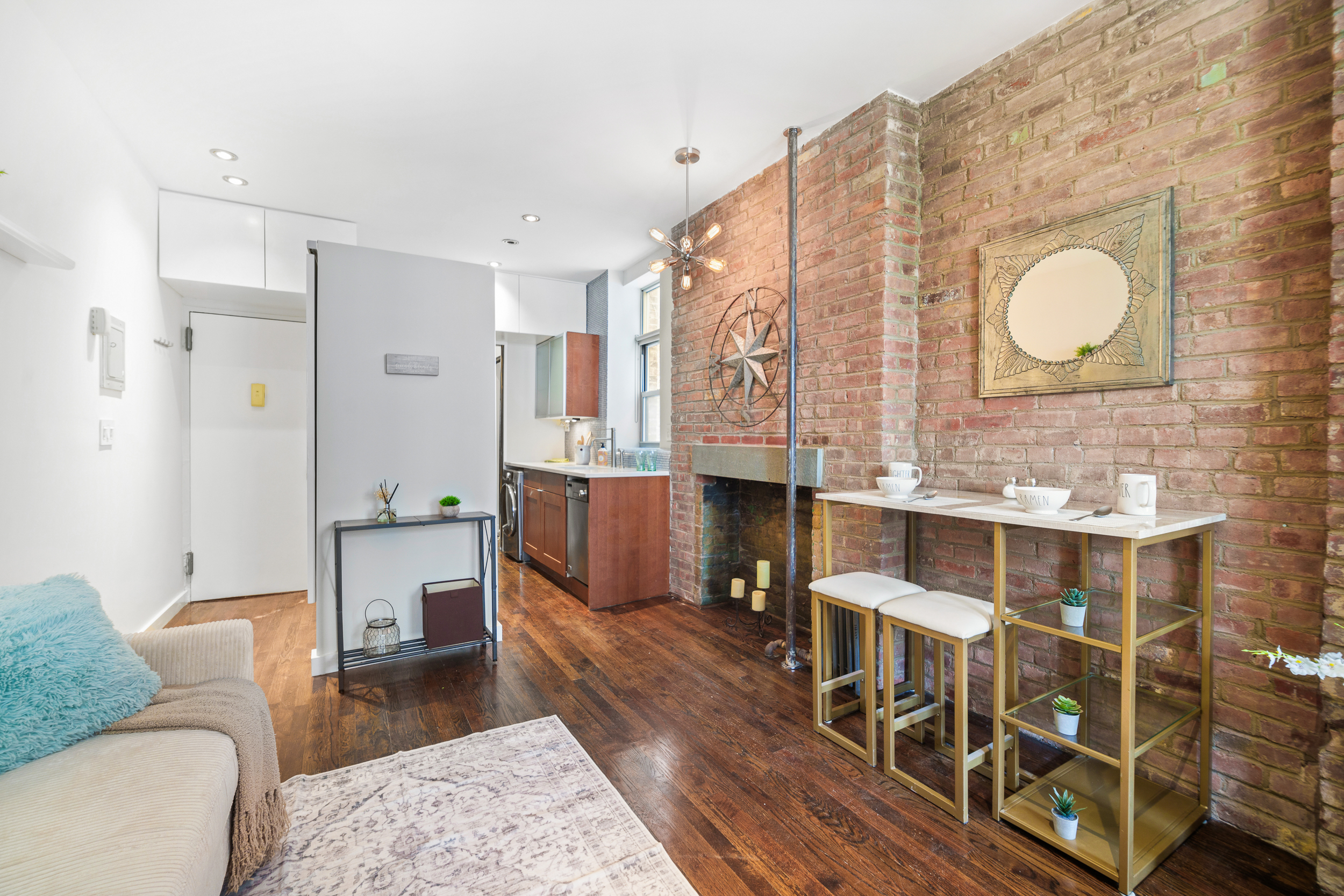 186 East 2nd Street, Unit 8 Manhattan, NY 10009 - Photo 4 of 8 a living room with furniture and wooden floor
