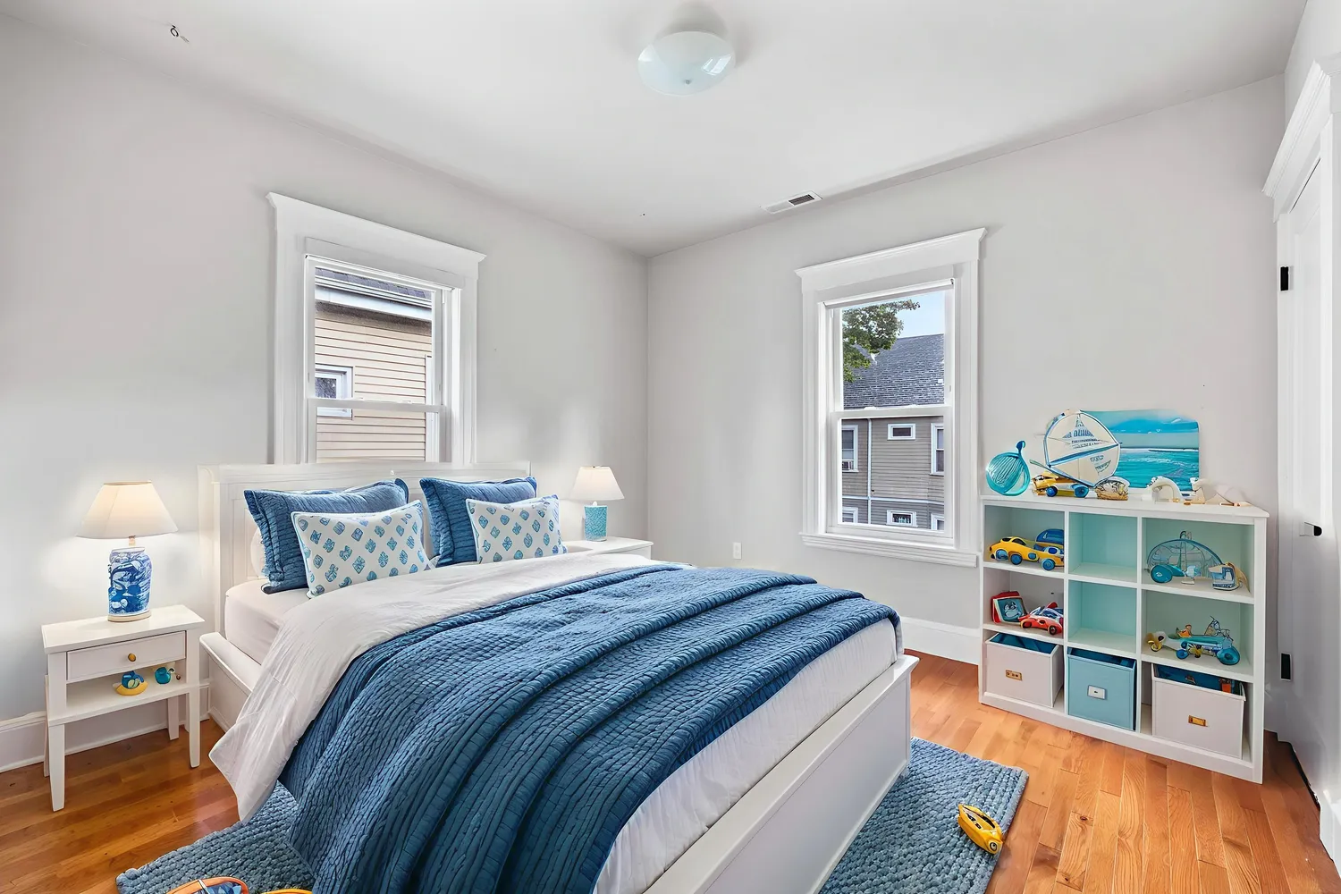 a bedroom with a bed and a wooden floor