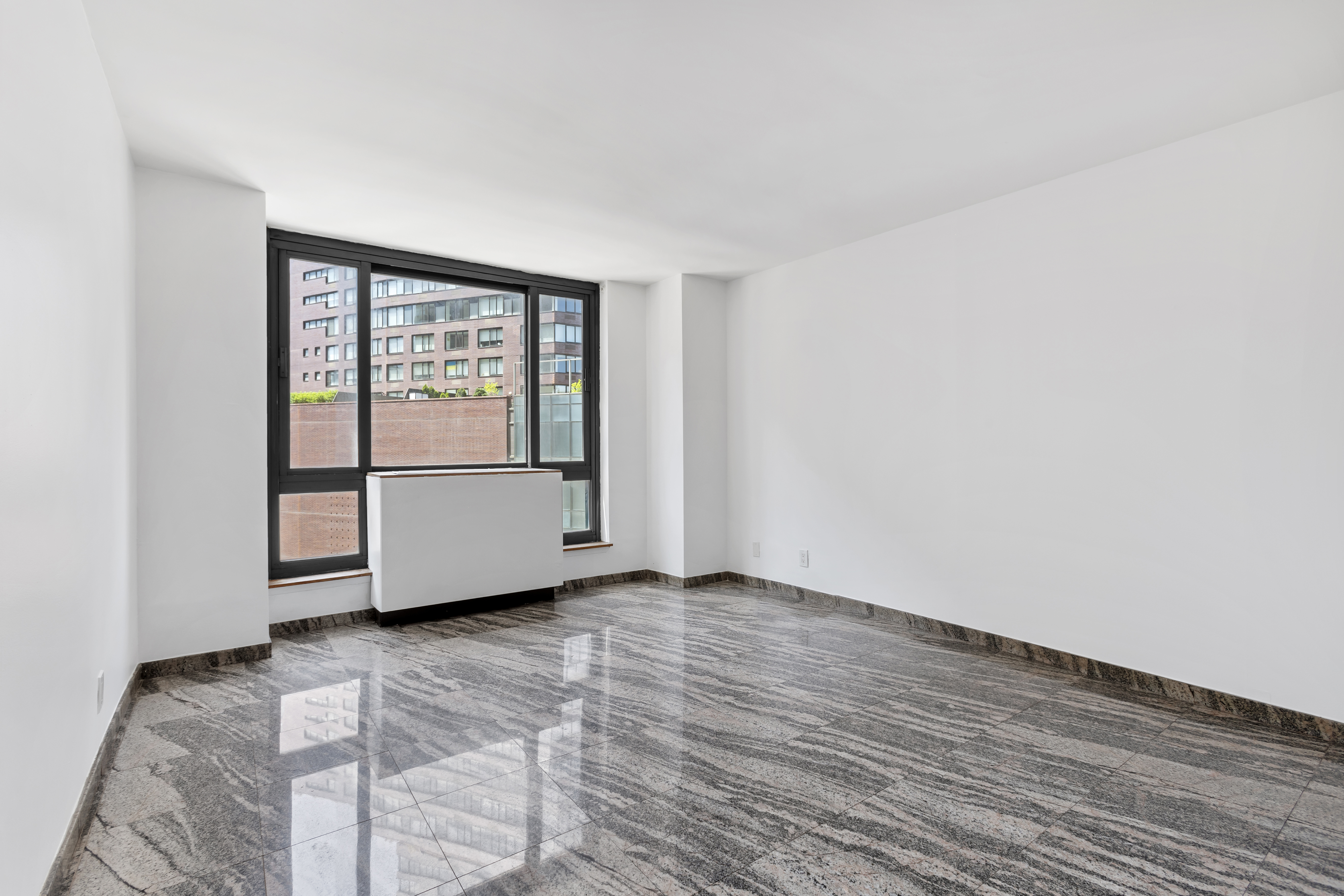 1 Irving Place, Unit U7BC Manhattan, NY 10003 - Photo 8 of 20 a view of an empty room with wooden floor and a window