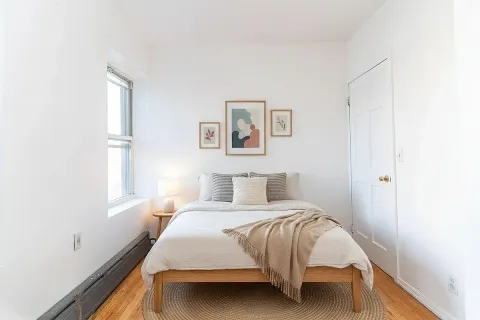 a bedroom with a bed and a window
