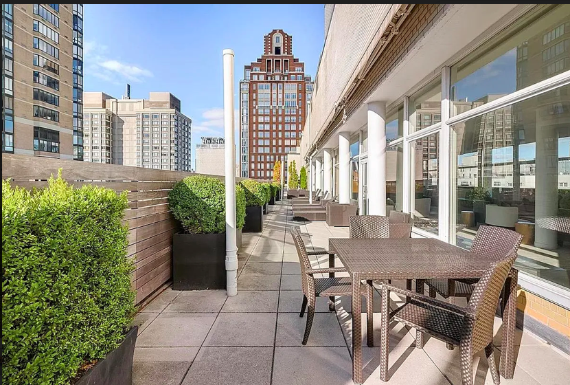 200 East 66th Street, Unit A407 Manhattan, NY 10065 - Photo 19 of 24 a view of a dining room with furniture and a floor to ceiling window