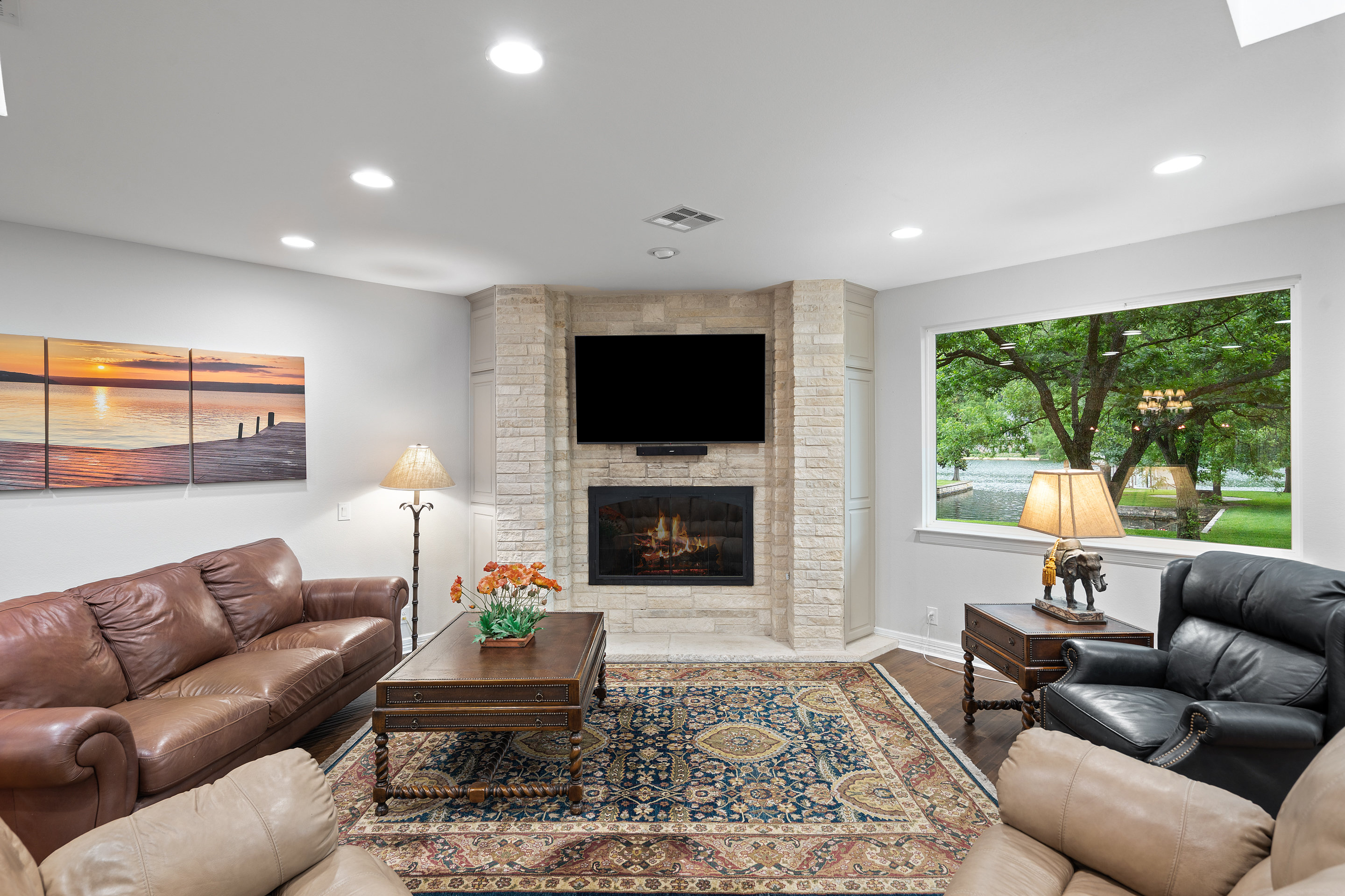 2603 Pearce Road Austin, TX 78730 - Photo 9 of 41 a living room with furniture a fireplace and a flat screen tv
