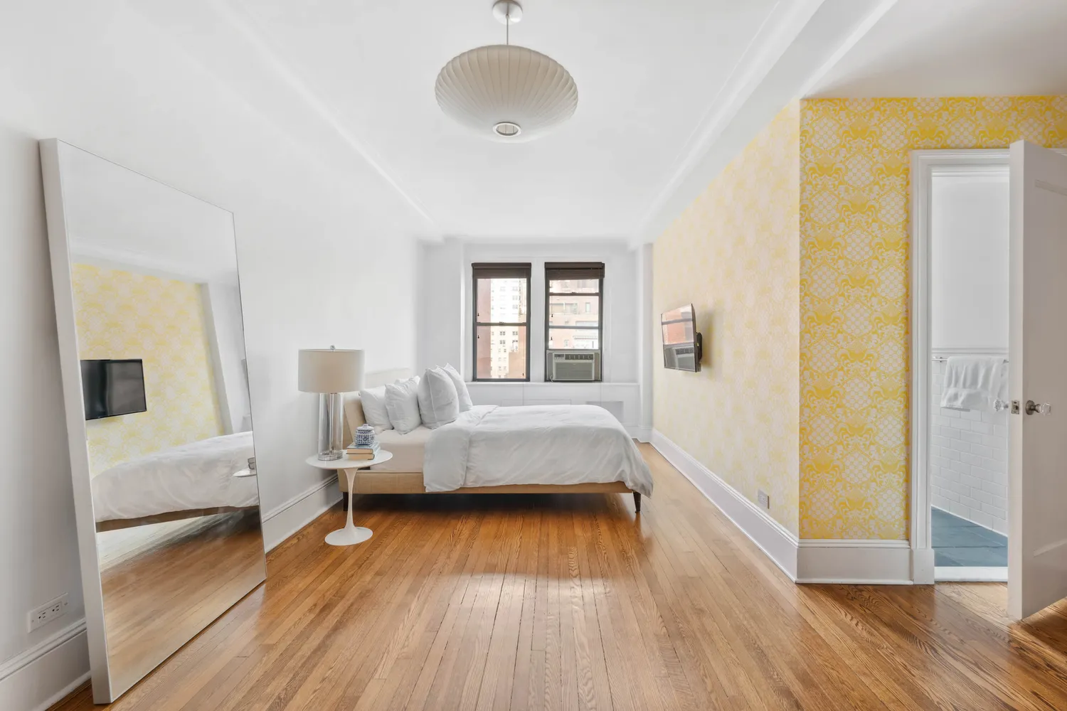 a bedroom with furniture and a wooden floor