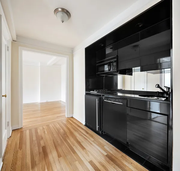 a kitchen with a refrigerator an oven