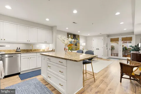 a kitchen with granite countertop a sink and cabinets