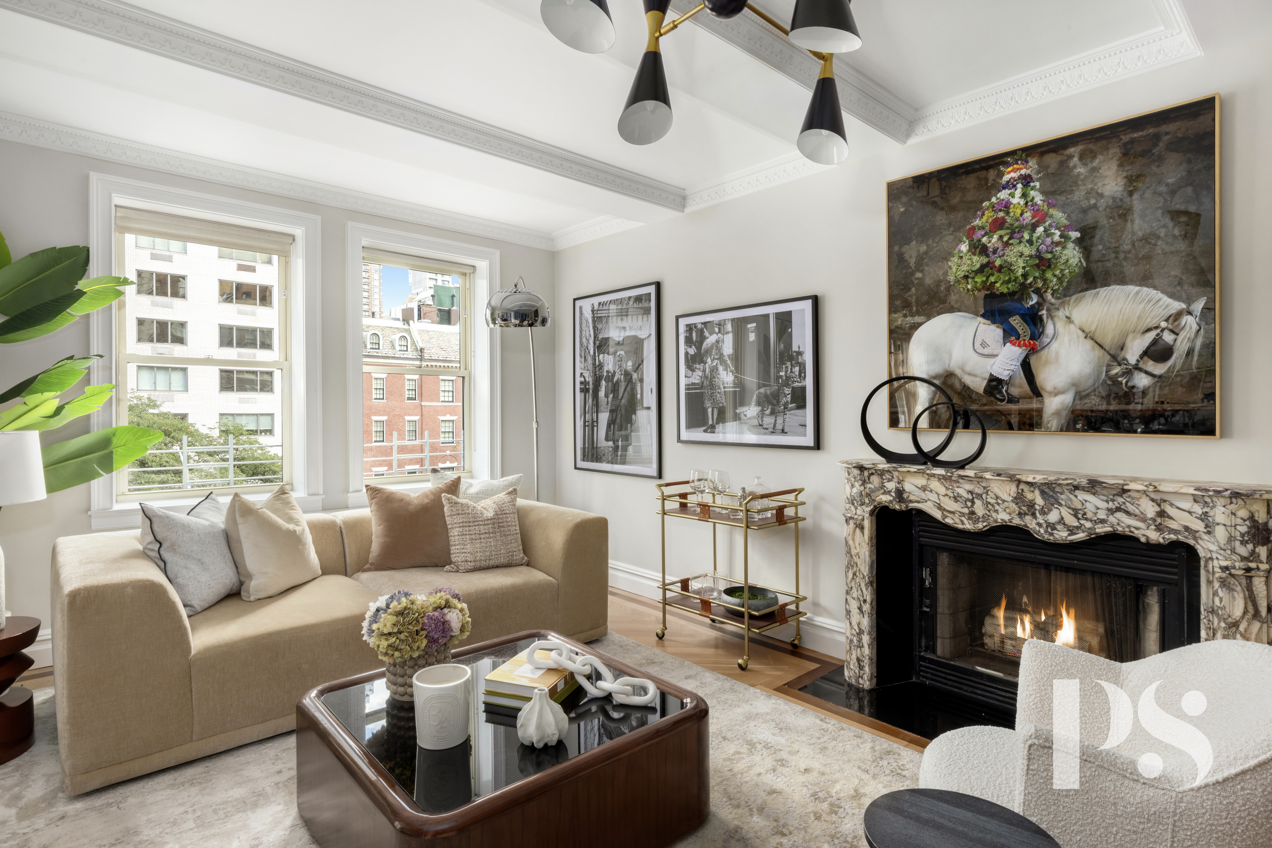 610 Park Avenue, Unit 4B Manhattan, NY 10065 - Photo 3 of 22 a living room with furniture a flat screen tv and a fireplace