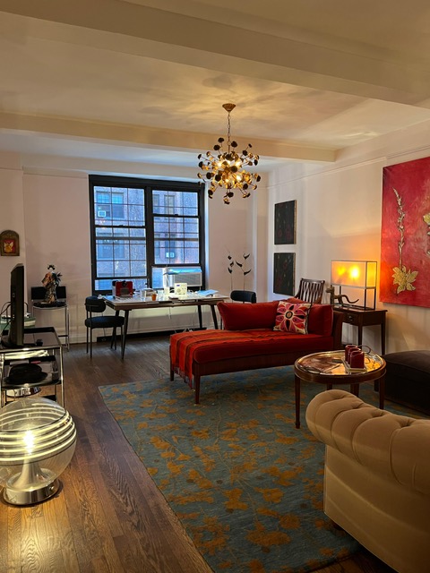 435 West 23rd Street, Unit 7B Manhattan, NY 10011 - Photo 4 of 23 a living room with furniture and a chandelier