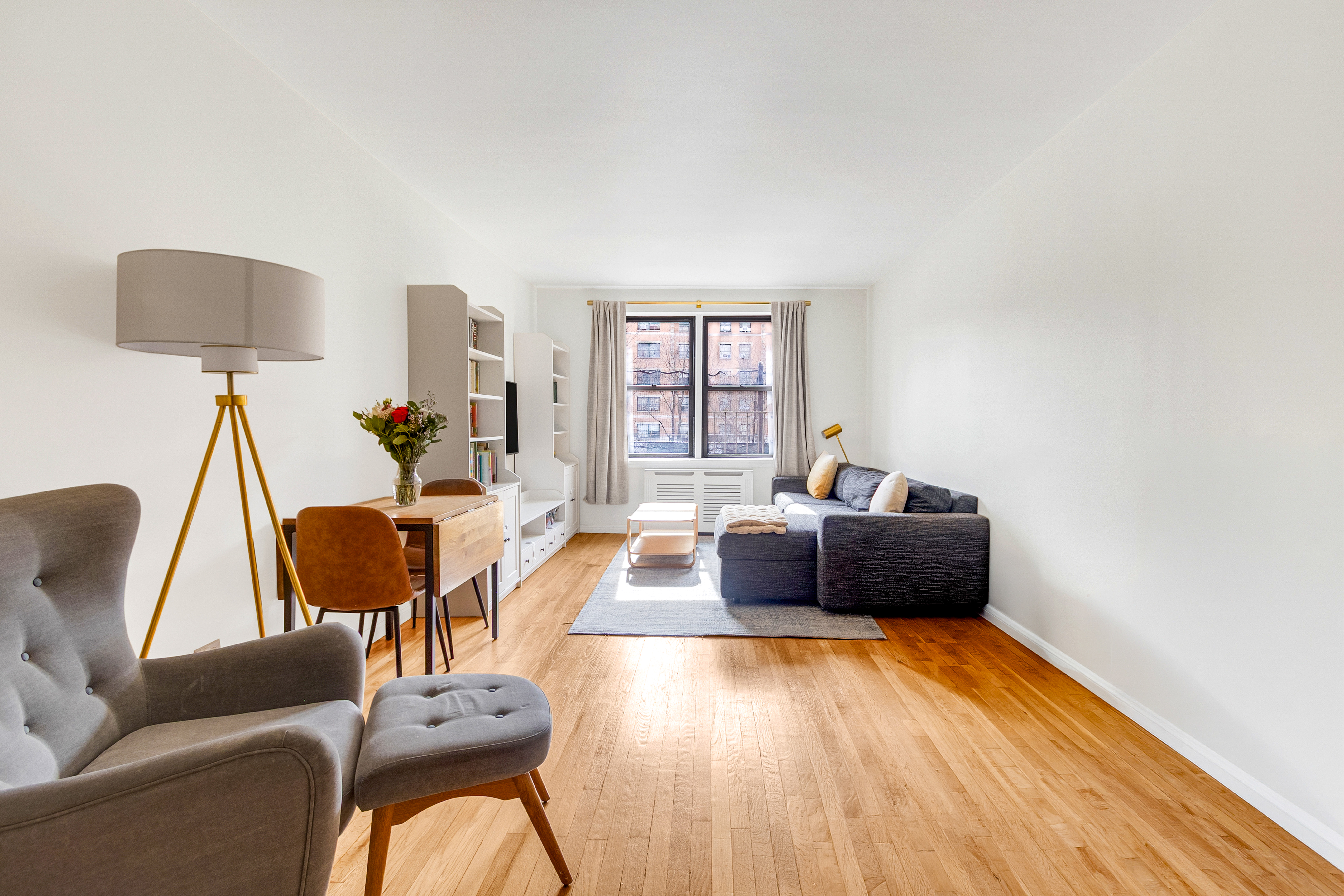 a living room with furniture and a wooden floor