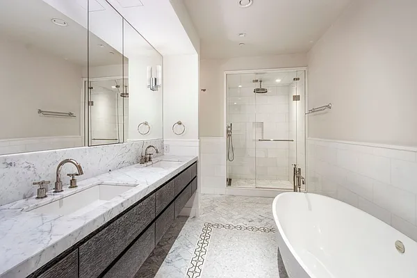 215 Sullivan Street, Unit THC Manhattan, NY 10012 - Photo 12 of 16 a bathroom with a tub sink double and mirror