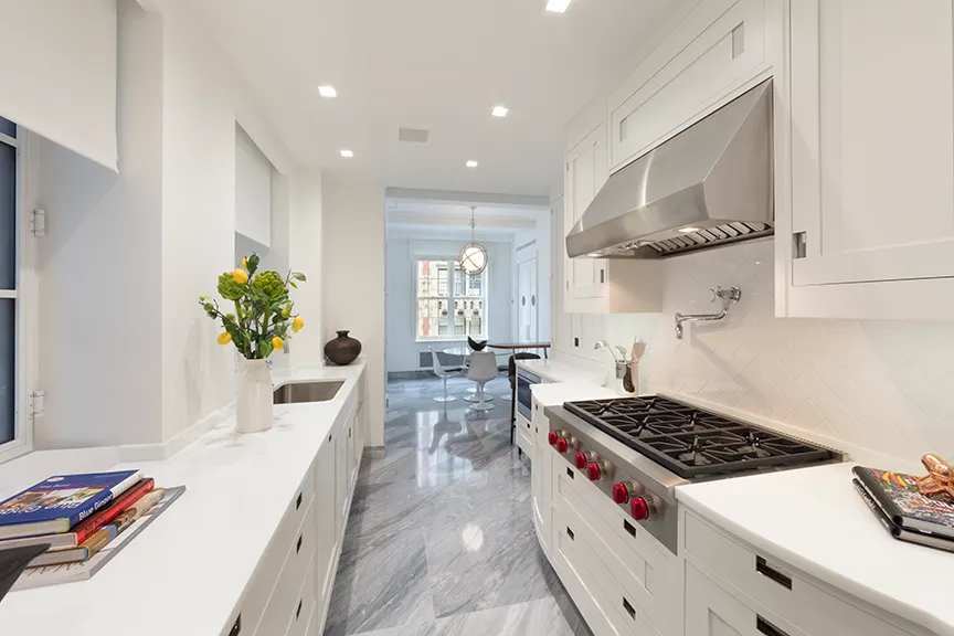 a kitchen with stove and cabinets