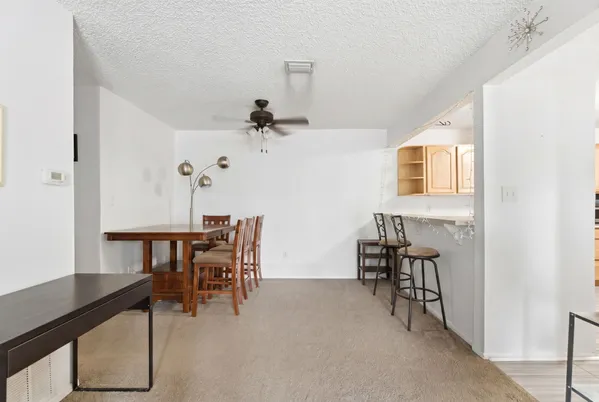 a dining room with wooden floor and a chandelier