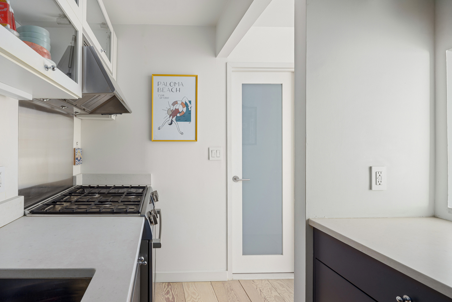 77 Bleecker Street, Unit 1006W Manhattan, NY 10012 - Photo 3 of 8 a view of kitchen cabinetry and stove