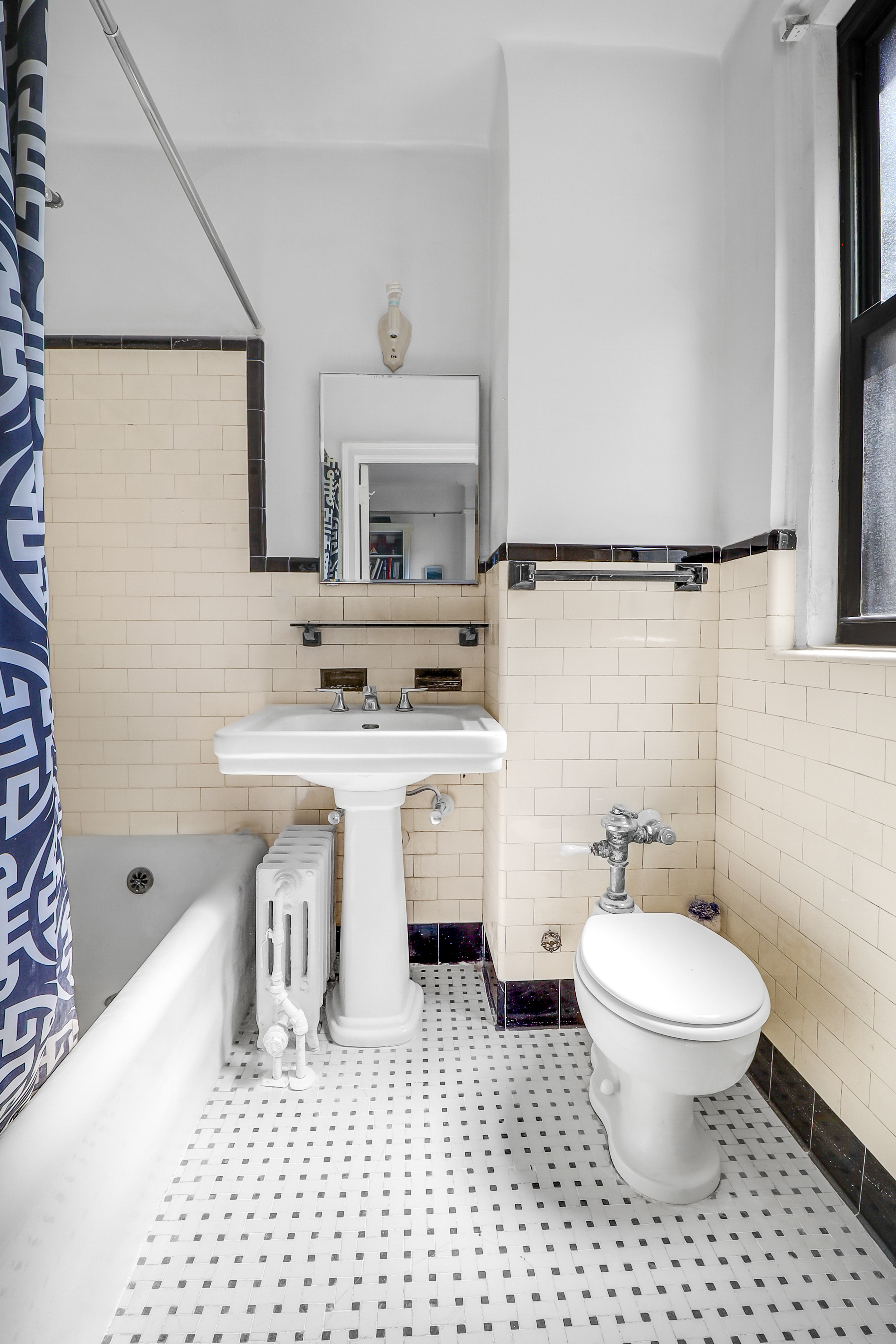 50 Riverside Drive, Unit 5E Manhattan, NY 10024 - Photo 9 of 22 a bathroom with a sink toilet a mirror and shower