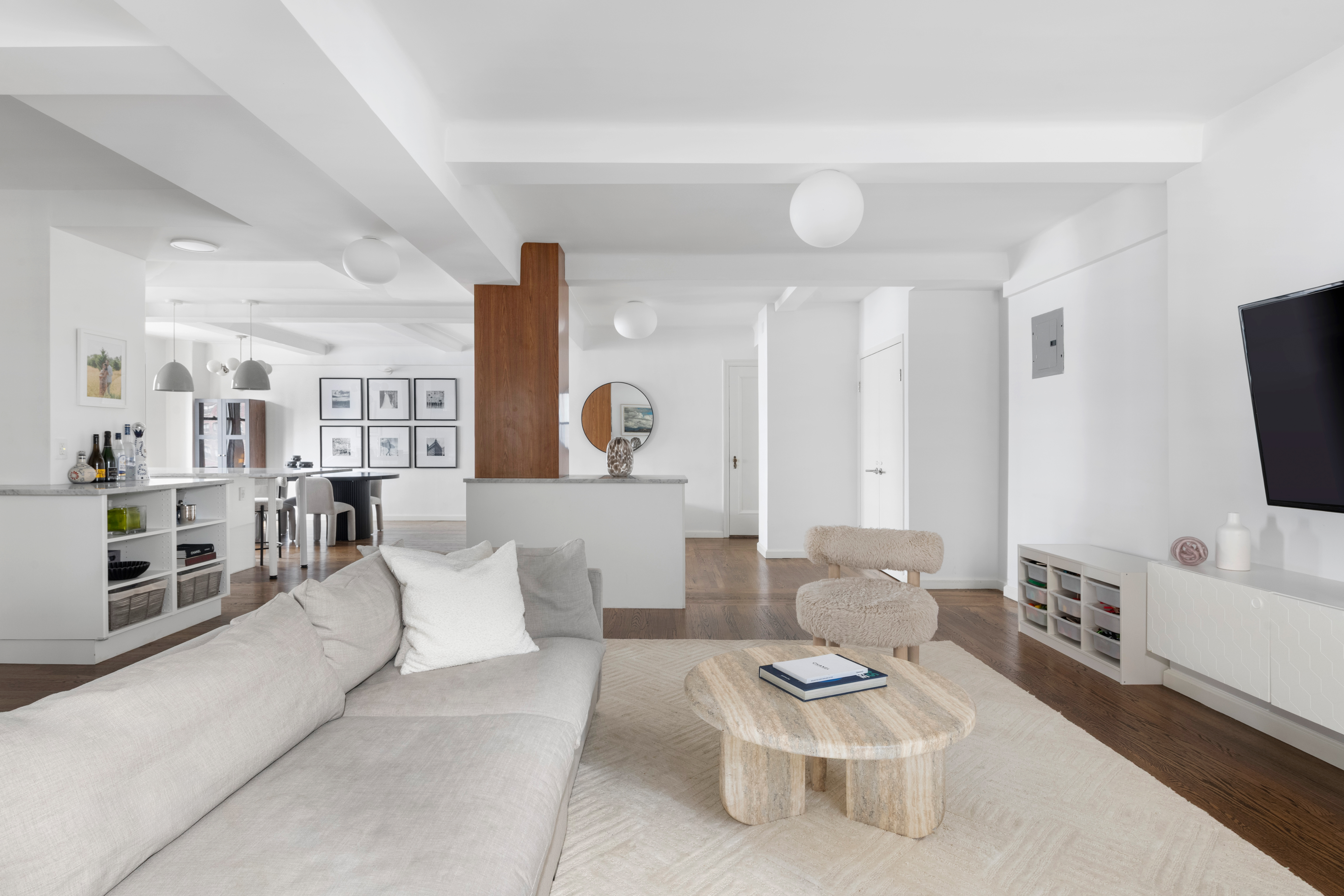 308 East 79th Street, Unit 13EF Manhattan, NY 10075 - Photo 2 of 16 a living room with furniture and a flat screen tv