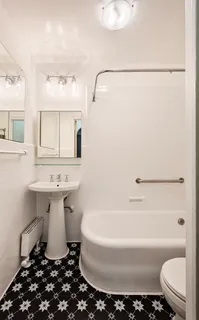 a bathroom with a sink toilet and a mirror