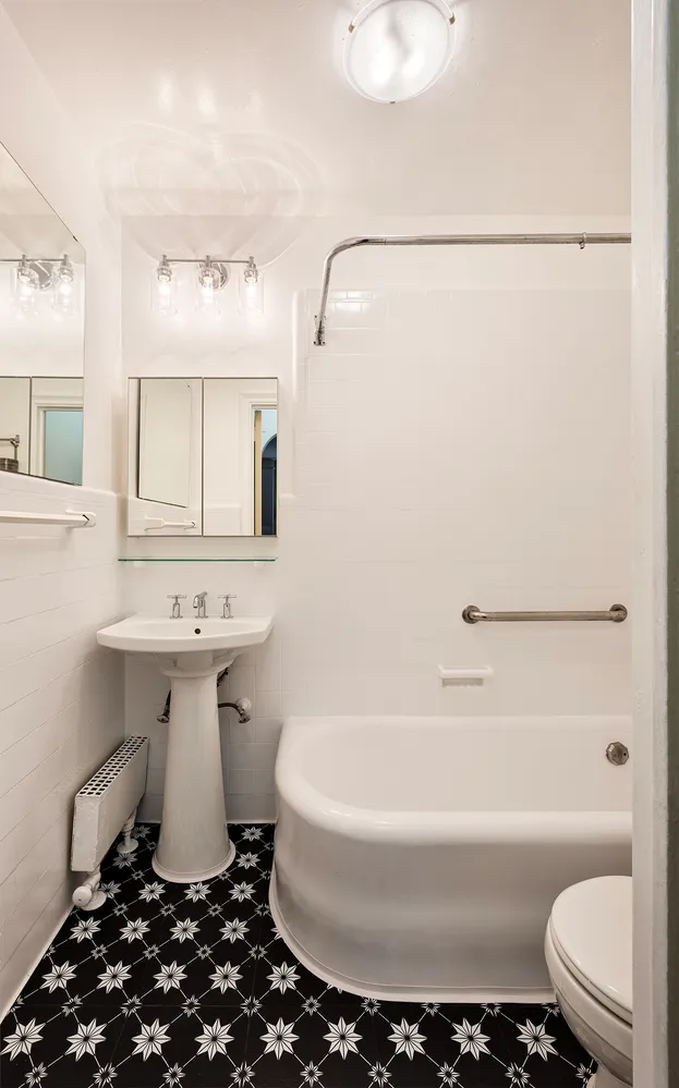 a bathroom with a sink toilet and a mirror