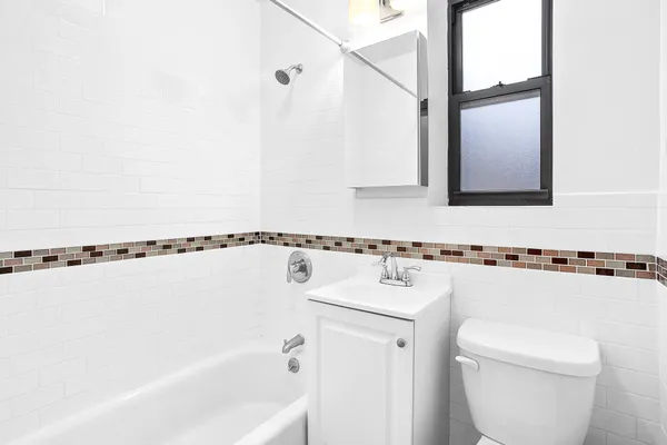 a bathroom with a shower a mirror and a sink