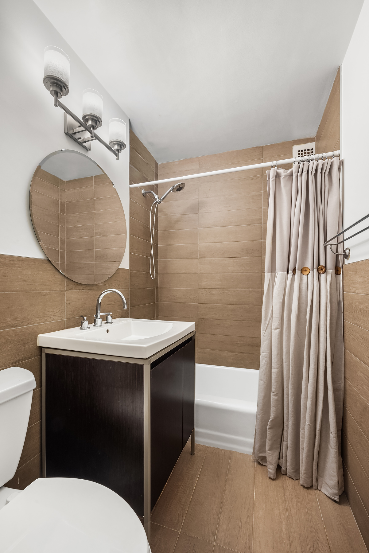 16 West 16th Street, Unit 3FS Manhattan, NY 10011 - Photo 5 of 12 a bathroom with a sink a toilet and shower