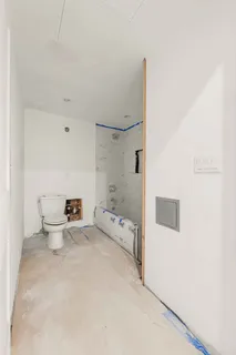 a bathroom with a toilet sink and shower