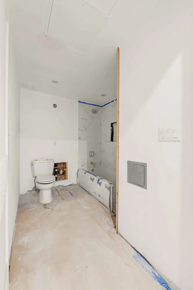 a bathroom with a toilet sink and shower
