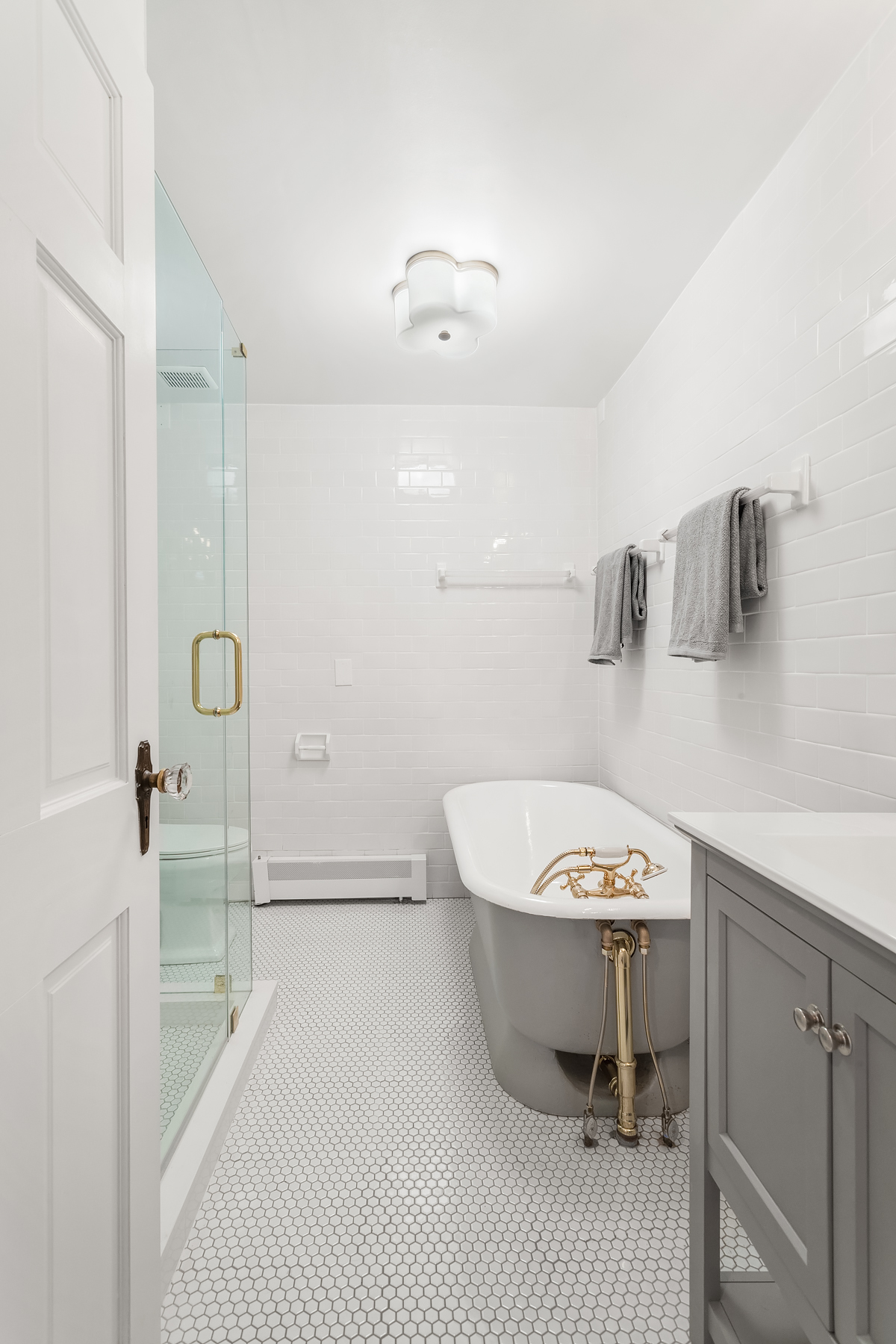 57 Sullivan Street, Unit DUPLEX Manhattan, NY 10012 - Photo 5 of 9 a bathroom with a tub a sink and a shower
