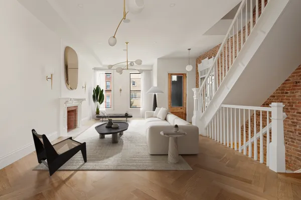 a living room with granite countertop furniture a fireplace and large windows