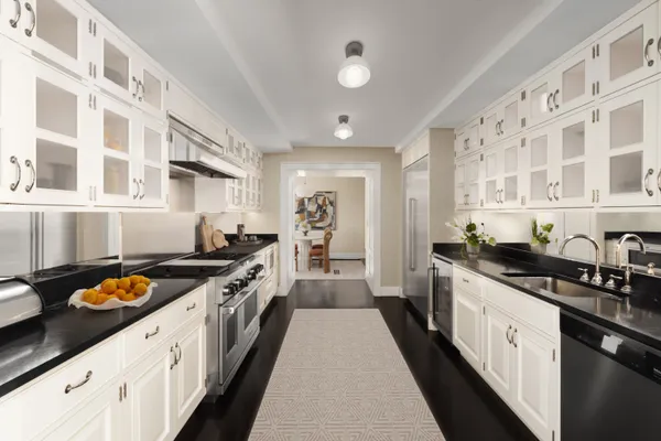 a kitchen with cabinets and stainless steel appliances