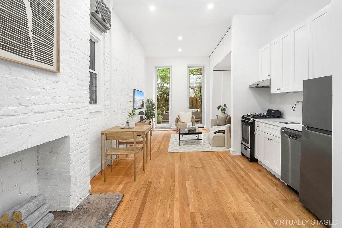 147 Sullivan Street, Unit 1A Manhattan, NY 10012 - Photo 1 of 6 a kitchen with a sink appliances and cabinets
