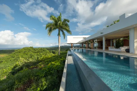 a living room with couch and a floor to ceiling window