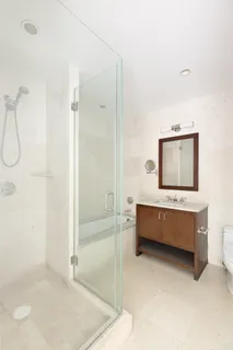 a bathroom with a double vanity sink a mirror and a bathtub