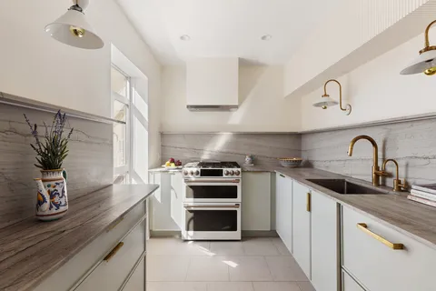 a kitchen with stainless steel appliances a stove a sink and a microwave